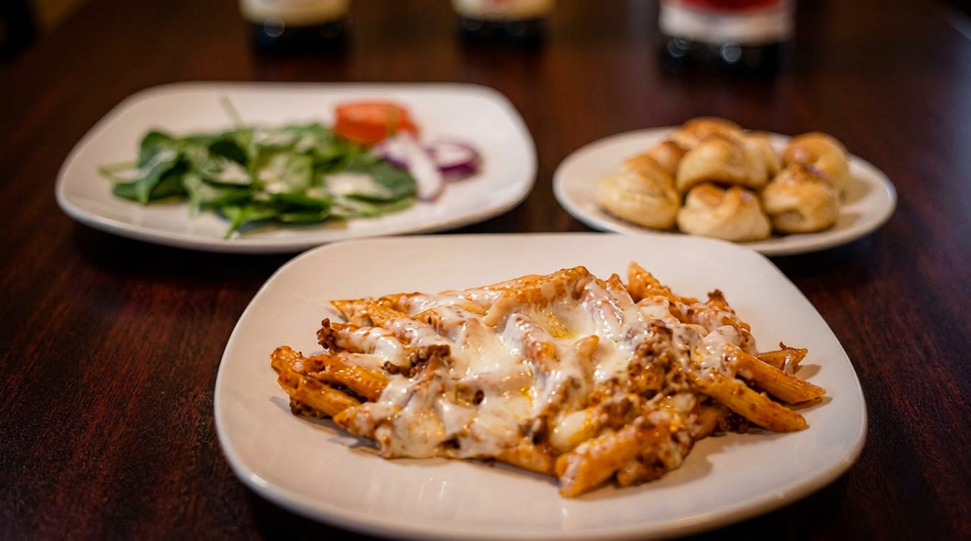 Pasta comes with salad and garlic knots