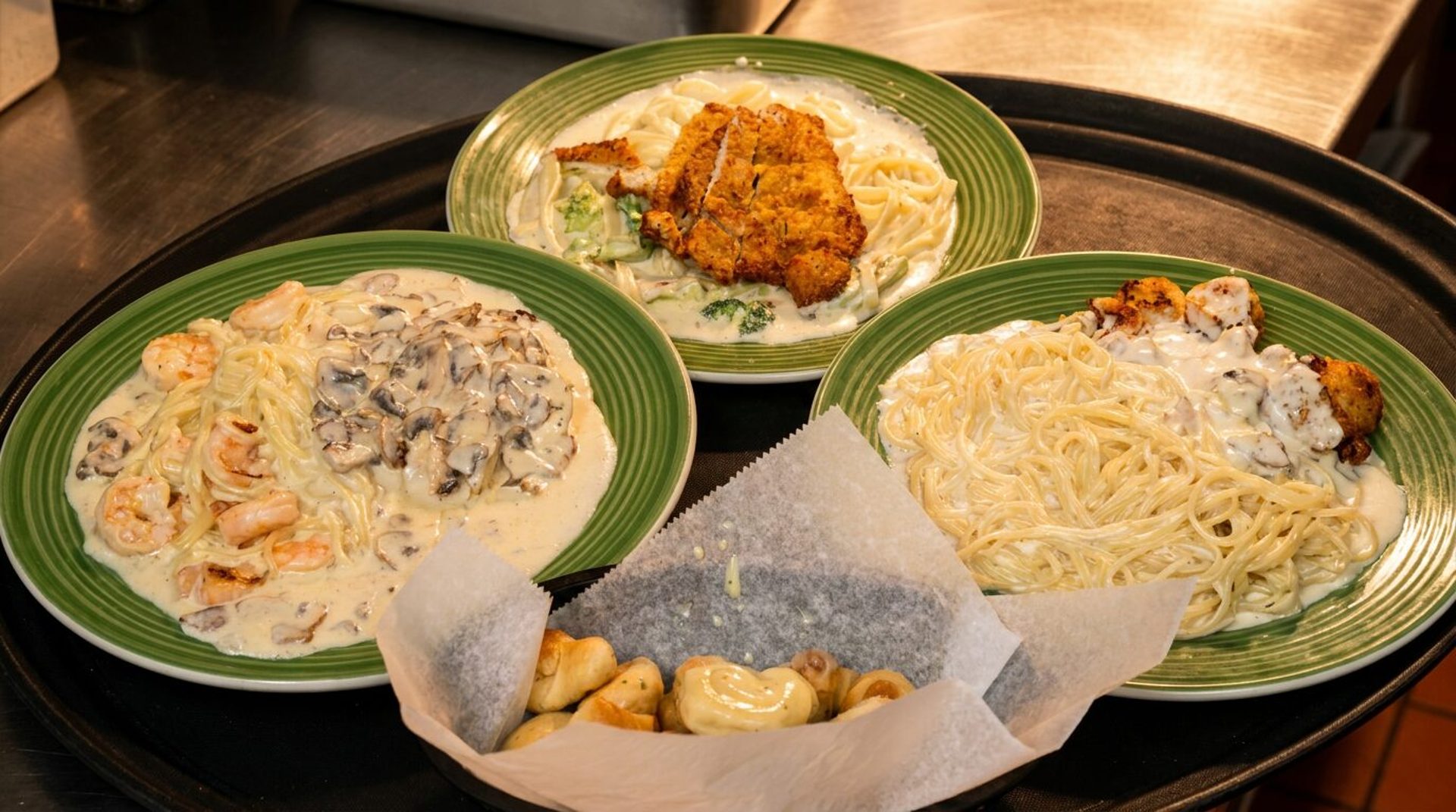 Pasta, pizza, and strombolis by the tray